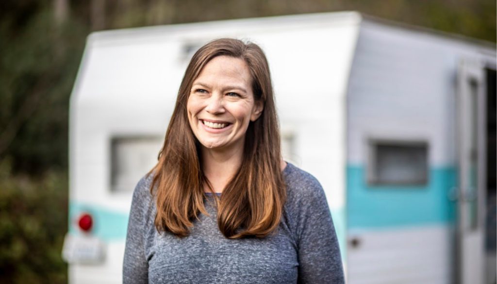 A photo of a woman smiling off center of the camera