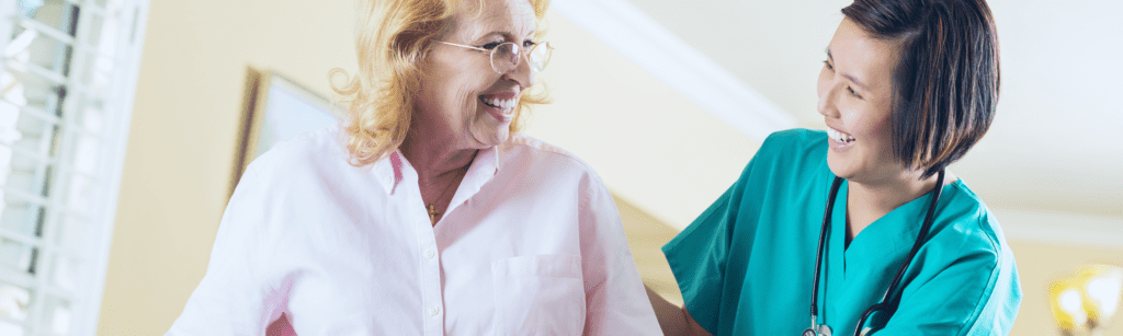 Image: nurse assisting elderly woman