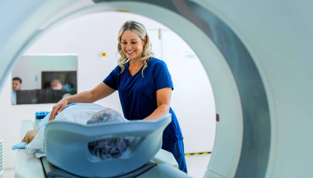 A healthcare professional assists a patient lying on a medical imaging scanner table.